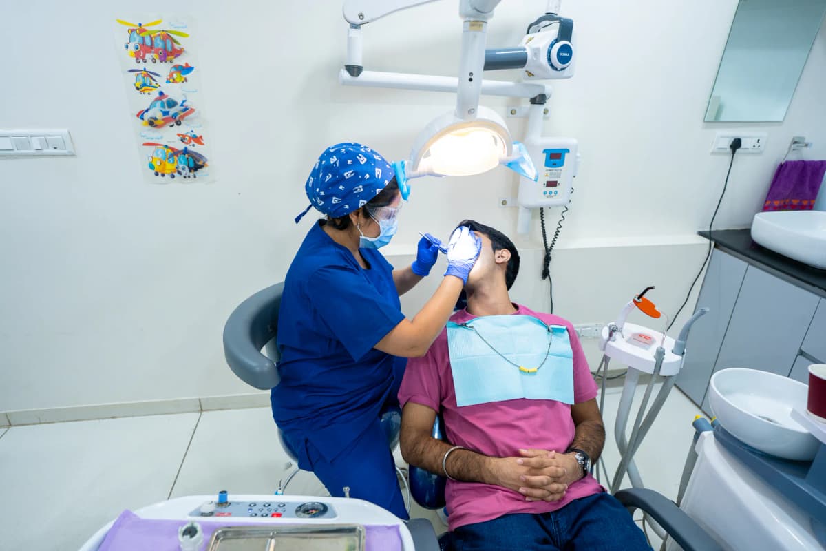 A patient receiving dental care at Floss & Gloss