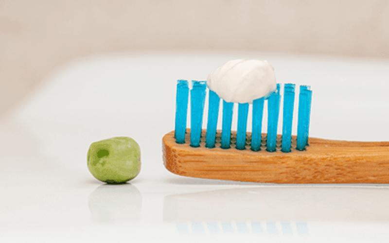 A small amount of toothpaste on a toothbrush
